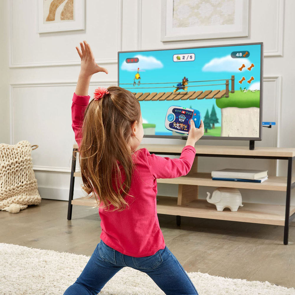 A girl is playing with the PAW Patrol To The Rescue Plug & Play Gaming Console by LeapFrog