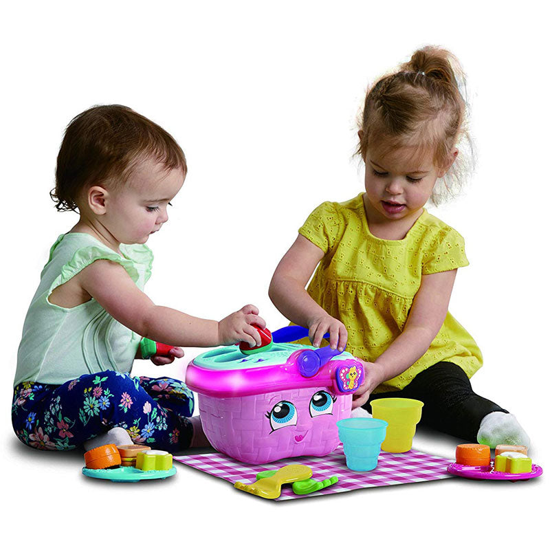 Two kids are playing with the Shapes & Sharing Picnic Basket Toy by LeapFrog
