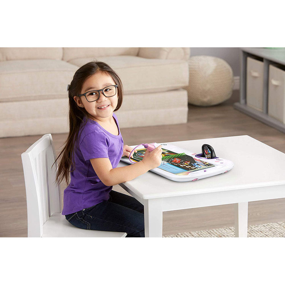 A girl is learning with the LeapStart 3D Interactive Learning System by LeapFrog