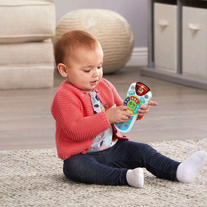 A baby is playing with the Scout's Learning Lights Remote Educational Toy by LeapFrog